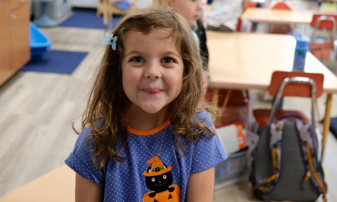 Forsyth Country Day School student in class, smiling.