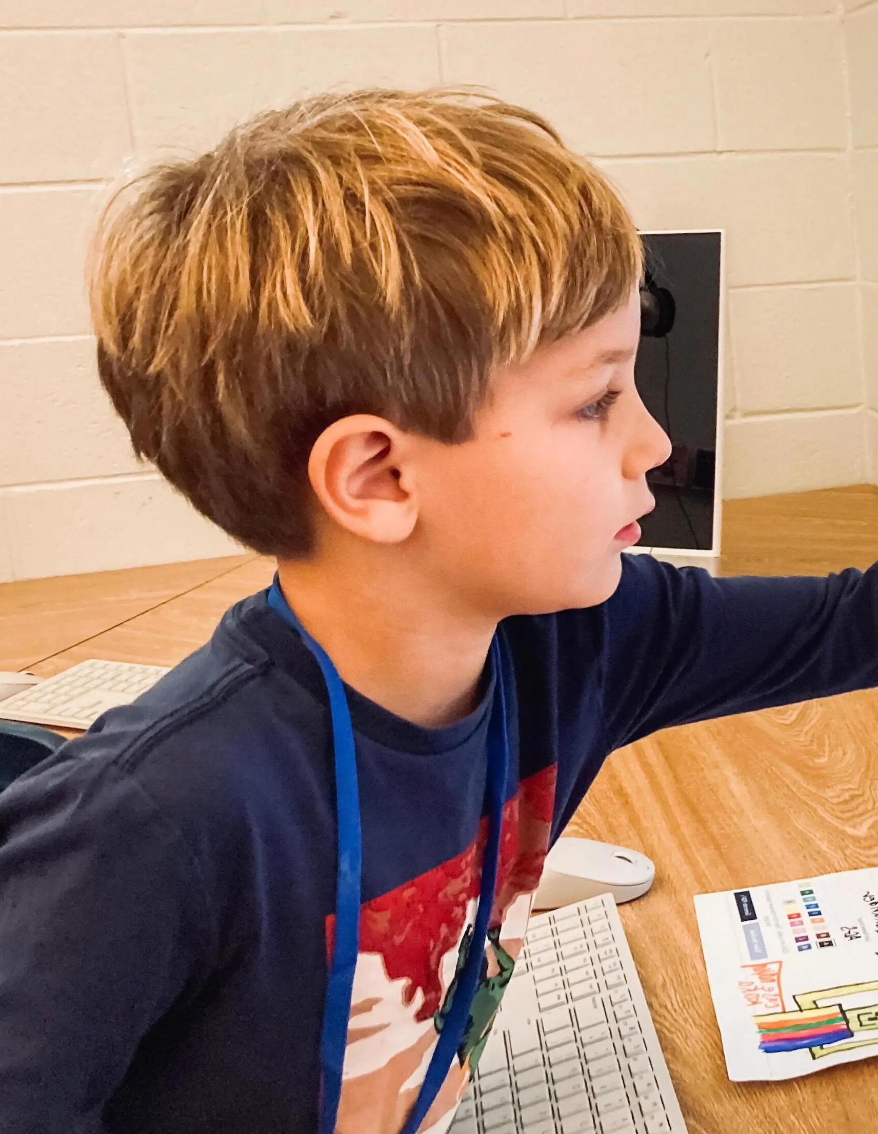 Student pointing at a computer