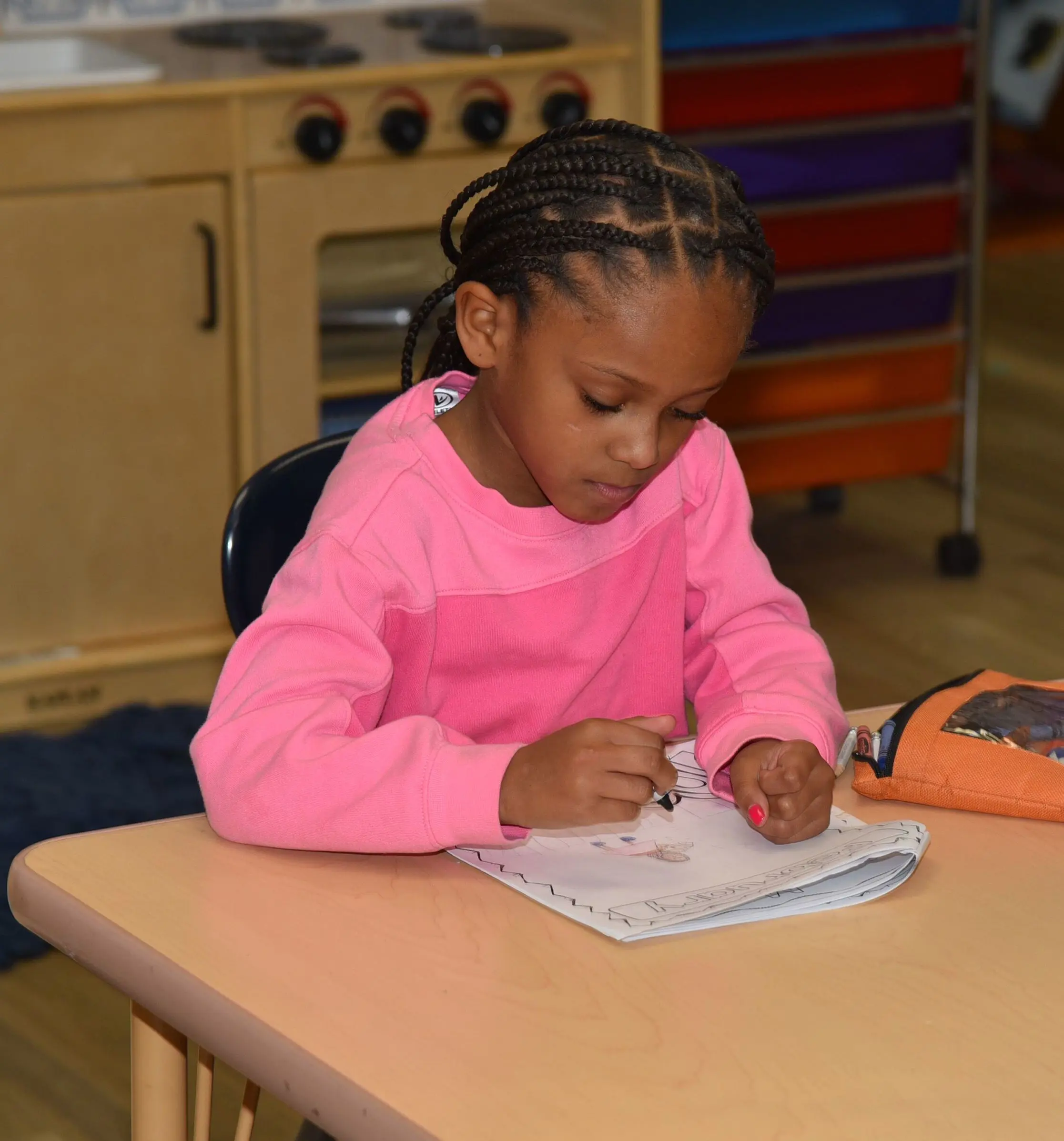 Student writing on a desk